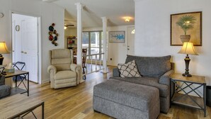 A living room with a grey sofa, a beige armchair, and a wooden coffee table. There is a lamp on a side table, and a framed picture on the wall. - Prosperity Vacation Rental ~ 1 Mi to Lake Murray! (Prosperity)