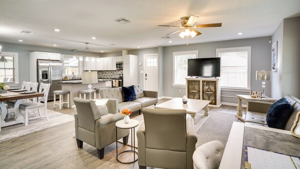 A spacious living room with a dining area, a kitchen, and a TV. - Lake Charles Home w/ Gas Grill & Fenced-in Yard! (Lake Charles)