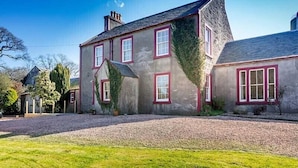 A two-story house with a gravel driveway and a grassy lawn. - Maxwelston Farmhouse (Girvan)