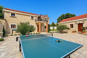 A courtyard with a ping pong table, stone buildings, and a red-tiled roof. - Villa Tereza - Four Bedroom Villa, Sleeps 8 (Prkos)