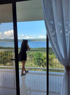 Enjoy breathtaking views of the sea and distant landforms from this balcony.