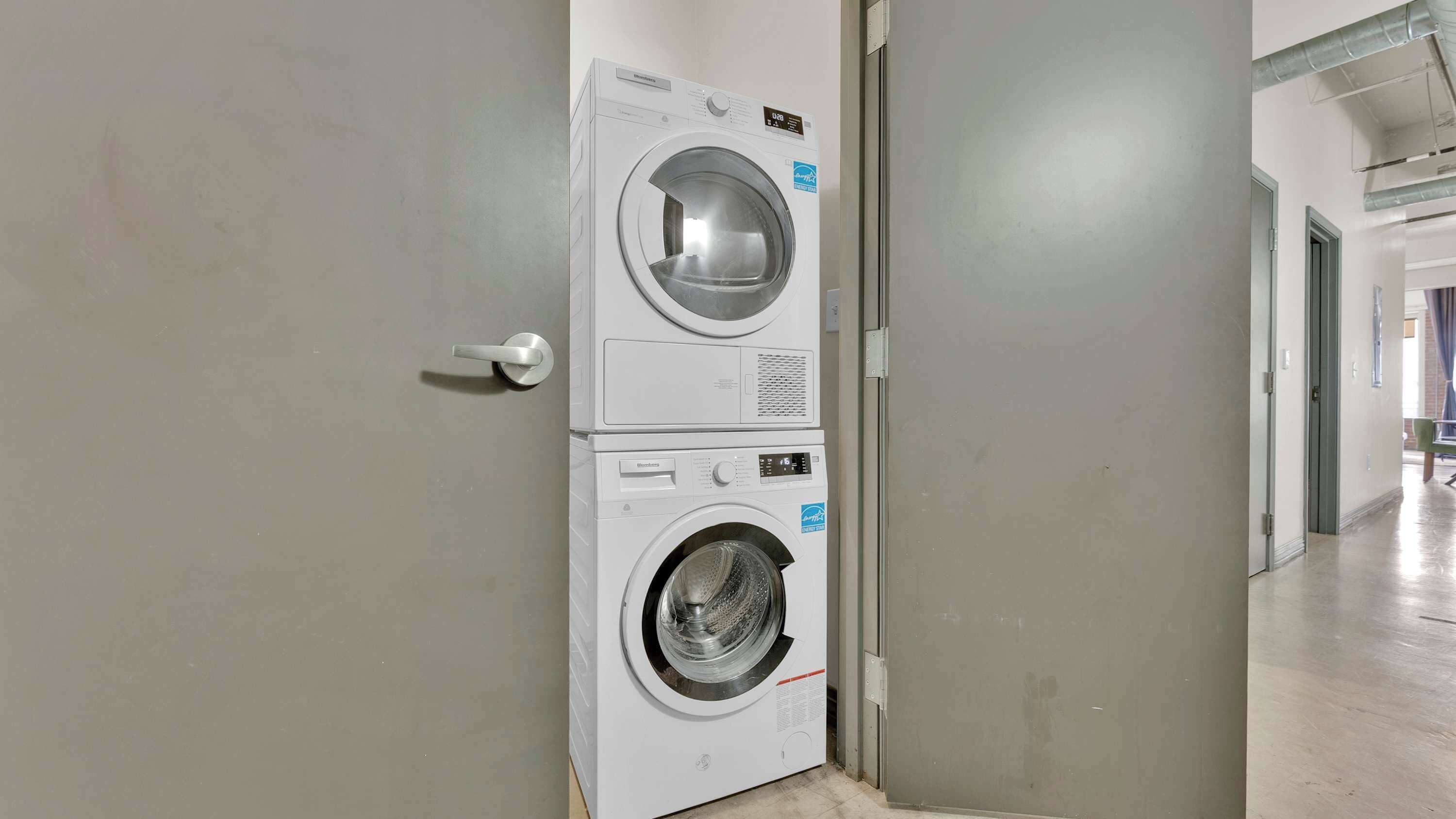 A laundry room with stacked washing machines.