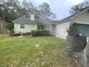 Stroll through the serene surroundings of this charming single-story home, complete with a lush lawn and a beautifully maintained yard.