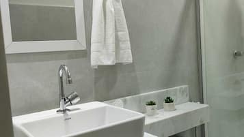 Shower, hair dryer, towels, toilet paper