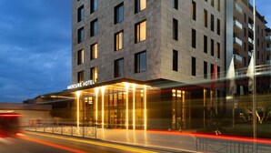 A modern hotel building with a prominent entrance and a well-lit facade. - Mercure Tirana (Tirana)