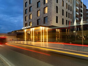 A modern hotel building with a prominent entrance and a well-lit facade. - Mercure Tirana (Tirana)