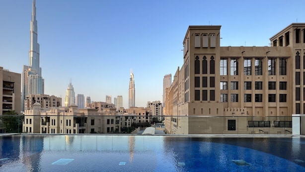 A swimming pool with a view of the Burj Khalifa and surrounding buildings. - Silkhaus Stunning Prime Design 1 BDR Gym Pool (Dubai)