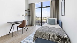 A modern hotel room with a large bed, a desk, and a chair. - Silkhaus Burj Khalifa Area Extra Single Room (Dubai)