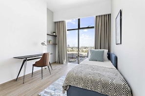 A modern hotel room with a large bed, a desk, and a chair. - Silkhaus Burj Khalifa Area Extra Single Room (Dubai)