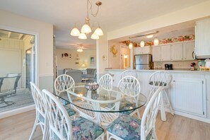 Enjoy a well-equipped kitchen with a sink, coffee maker, and refrigerator, and dine at a round table with comfortable seating.