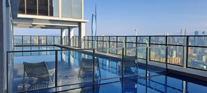A rooftop infinity pool with glass railings, a modern building, and a city skyline view. - Mercure Kuala Lumpur Trion (Kuala Lumpur)