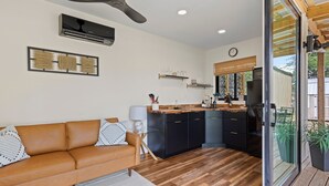 A modern kitchen with black cabinets, a wooden countertop, and a built-in oven. - One of a kind Romantic Luxe Retreat, 8 Minutes to Emerald Beach, Outdoor Haven (Navarre)
