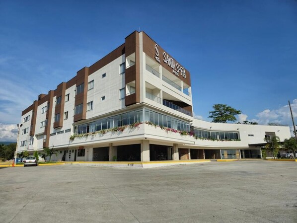 Un hôtel à plusieurs étages au design moderne, sur lequel on peut voir un grand panneau indiquant « SANTA SOPHIA ».