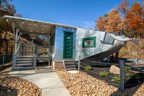 Un edificio con una puerta verde y un porche cubierto.