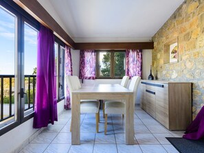 Enjoy meals in the spacious dining area with a large table and comfortable chairs.