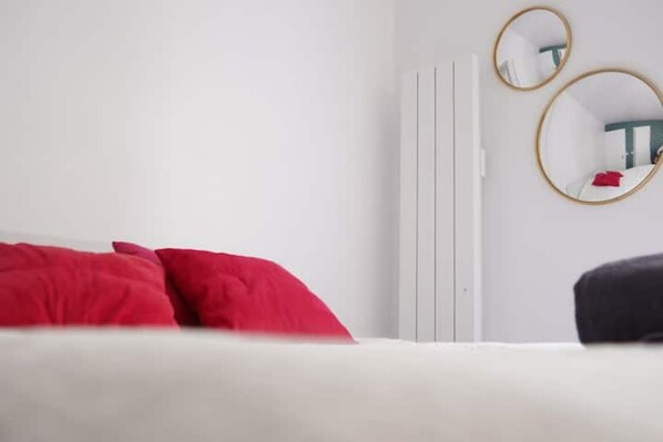 Simple, clean design with a white bed and gold accents.