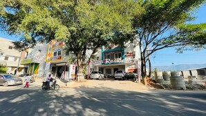 A street view with a building labeled "Raj Residency" and parked cars. - Raja residency near ISHA ADIYOGI ALANDURAI Siruvani Coimbatore ,Tamilnadu, India (Alanthurai)