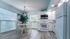 A modern kitchen with white cabinetry, a built-in oven, and a microwave. - Siesta Shores: Shoreline Suite - King bed - Pool! (Sarasota)