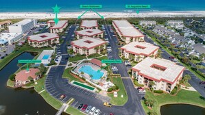An aerial view of a resort with a community pool, clubhouse, and beach walkovers leading to St. Augustine Beach. - Ocean and Racquet 8208 (St. Augustine)