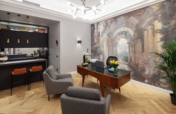 A modern kitchen with a bar area, a dining table with chairs, and a large mural on the wall. - Migliori Collection Piazza Navona 71 (Rome)