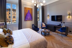 A hotel room with a large bed, a desk, a chair, a television, and a painting on the wall. - Migliori Collection Piazza Navona 71 (Rome)