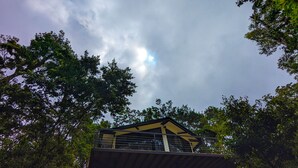 A building with a balcony, surrounded by trees. - Quality Cabins Monteverde #4 (Monteverde)