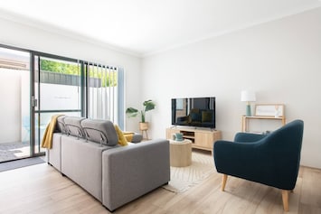 Modern living space with a comfy couch and entertainment setup.