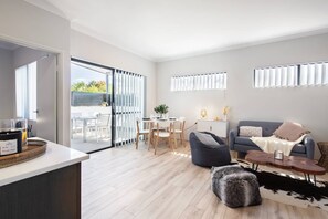Light-filled and spacious, this inviting living room opens onto the balcony, seamlessly blending indoor comfort with outdoor living.