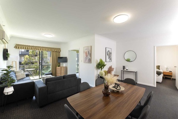 Spacious open-plan living and dining area, offering comfortable seating and a welcoming atmosphere.