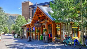 A wooden building with a sign reading "McCoy's Mountain Market" offering groceries and beer.