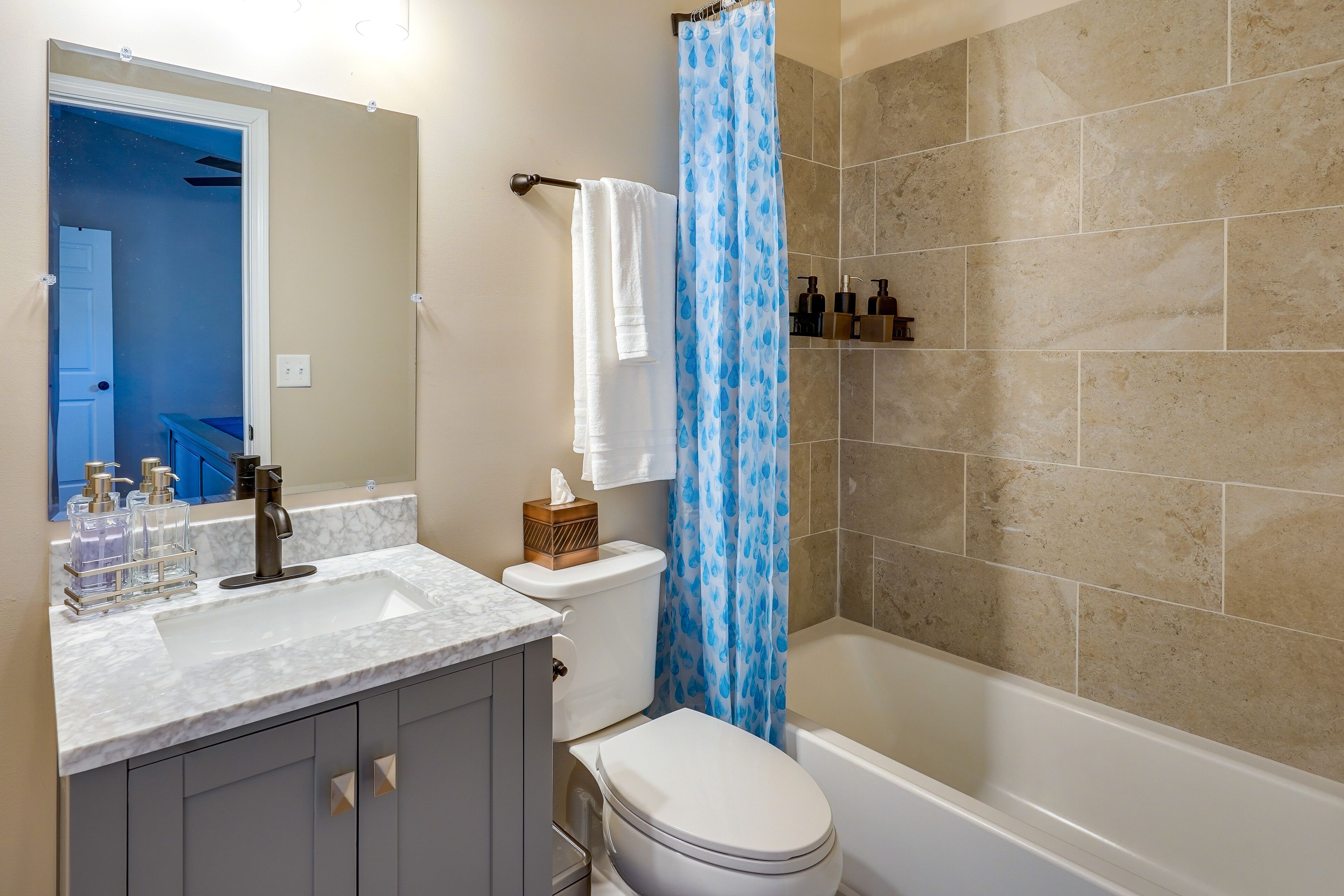 A bathroom with a white sink, a toilet, and a bathtub.