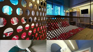 A modern hotel room with a large window, a decorative perforated partition, a round mirror, and a bathroom with a stone sink and shower. - B&B del corso foggia (Foggia)
