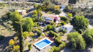 An aerial view of a property with a swimming pool, multiple buildings, and surrounding greenery. - Cubo's La Maison de Mily / fireplace / private pool / free wifi (Coín)