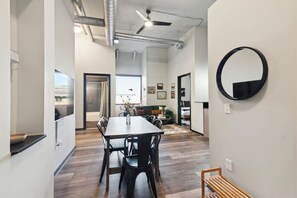 Cozy dining area with a wooden table and comfortable seating, perfect for meals and relaxation.