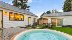A residential backyard with a swimming pool, a patio with outdoor furniture, and a covered patio area. - Walk to the waterfront- Charmwood House  (Tacoma)