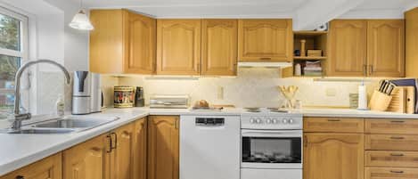Fridge, stovetop, dishwasher, coffee/tea maker