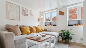 Un salon confortable avec un canapé, une table basse et une plante en pot.