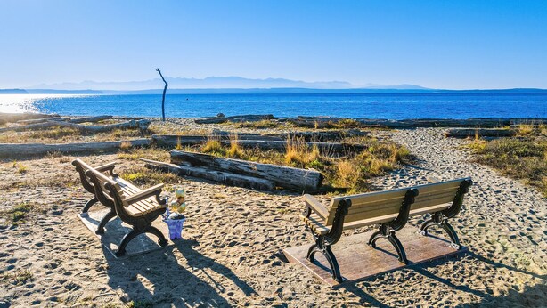A beach with two wooden benches and a trash bin. - Pirates Perch I Whidbey I Hot Tub I King Bed (Freeland)