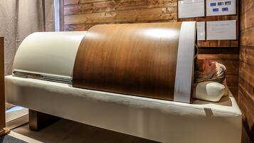 A wooden wall with a bench and informational signs.
