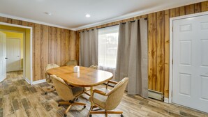 A conference room with a wooden table, four chairs, and a white door. - Quiet Country Home By Shay Lake! (Silverwood)