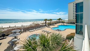 A resort with a pool, beach, and ocean view.