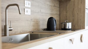 A modern kitchen with a stainless steel sink, a kettle, and a pot on the counter. - GuestHost - Casa Maya - Prime Central Apartment (Salerno)