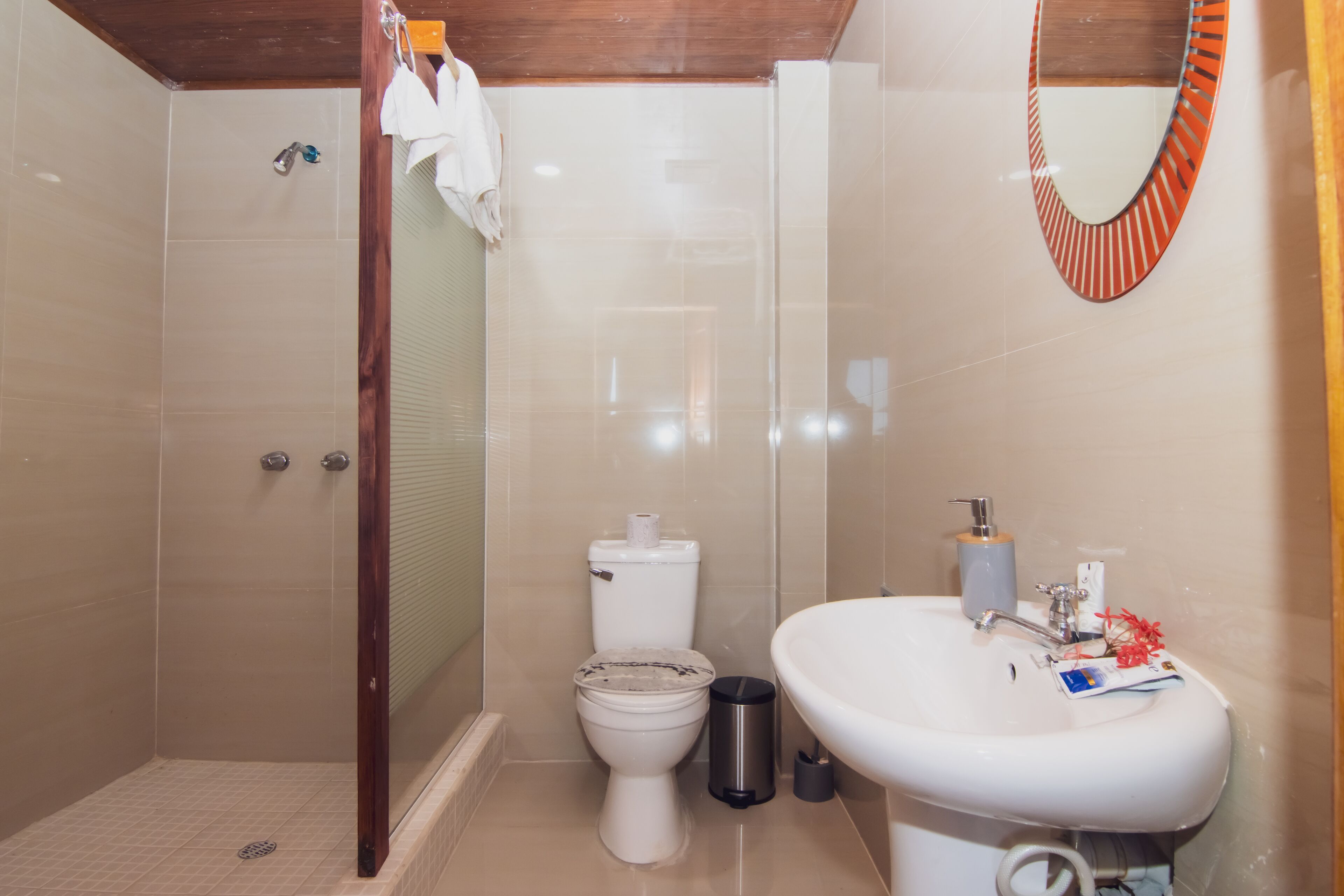 A bathroom with a shower, toilet, and sink.