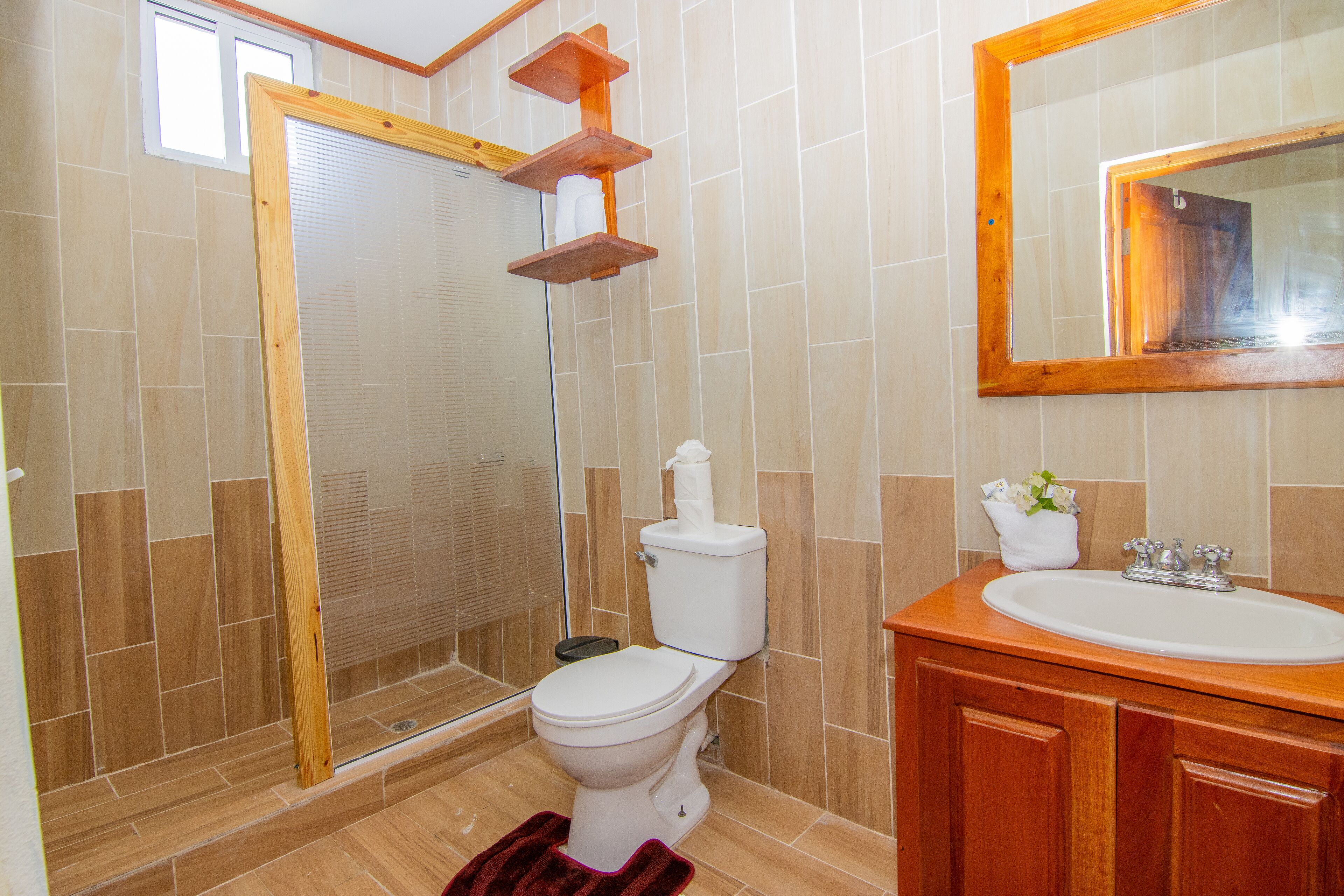 A bathroom with a toilet, sink, and shower.