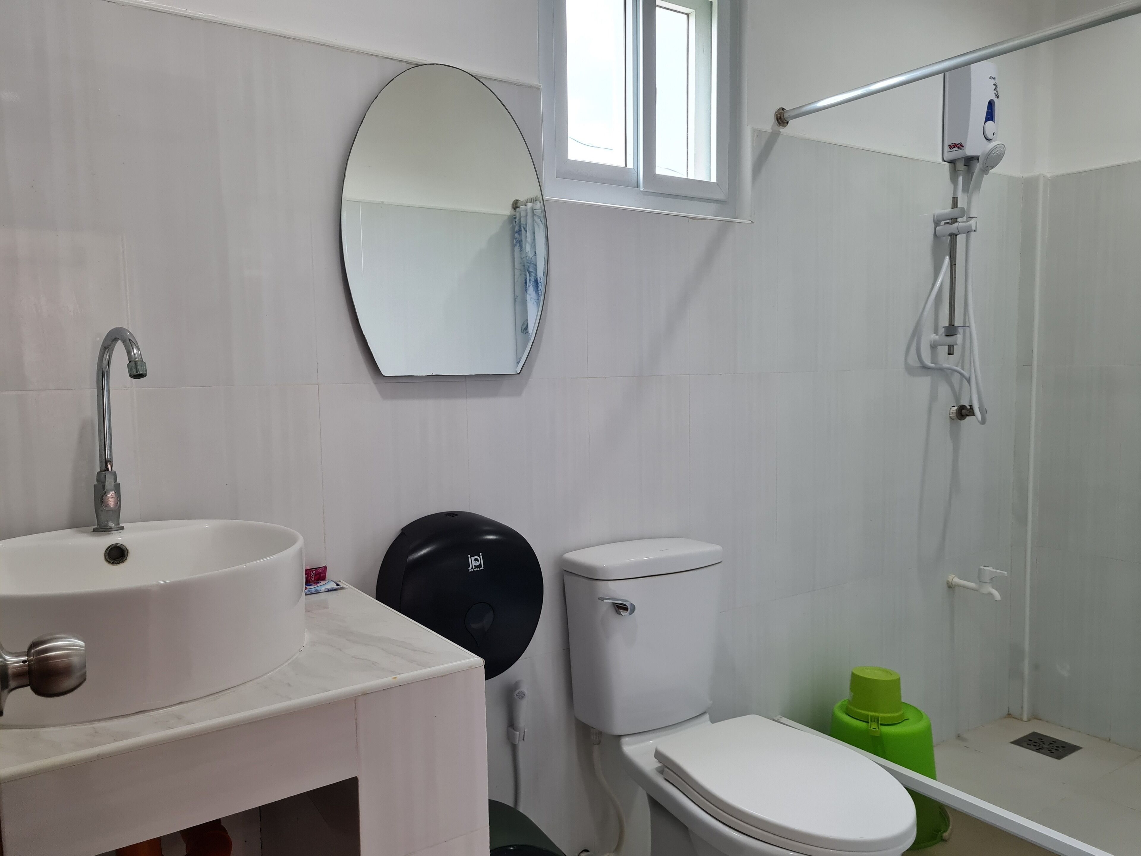 A bathroom with a sink, toilet, and shower.