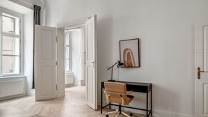 A modern office space with a desk, chair, and a framed picture on the wall.