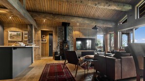 A cozy living room with a fireplace, a TV, and comfortable seating. - Awesome home in Hornindal with WiFi (Hornindal)