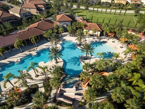 A resort with multiple swimming pools, palm trees, and a well-maintained lawn. - Orlando Dream Home (Davenport)