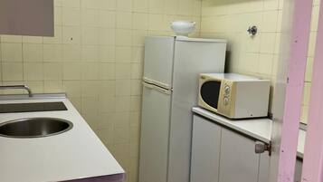 Fridge, microwave, coffee/tea maker, cookware/dishes/utensils