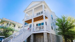 A two-story house with a balcony and a staircase leading to the second floor. - Sojourn on Lea View | Willoughby Spit | 5 BR *NEW* (Norfolk)